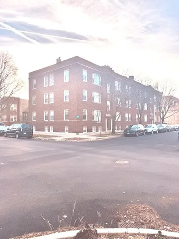 a view of a street with a building in the background