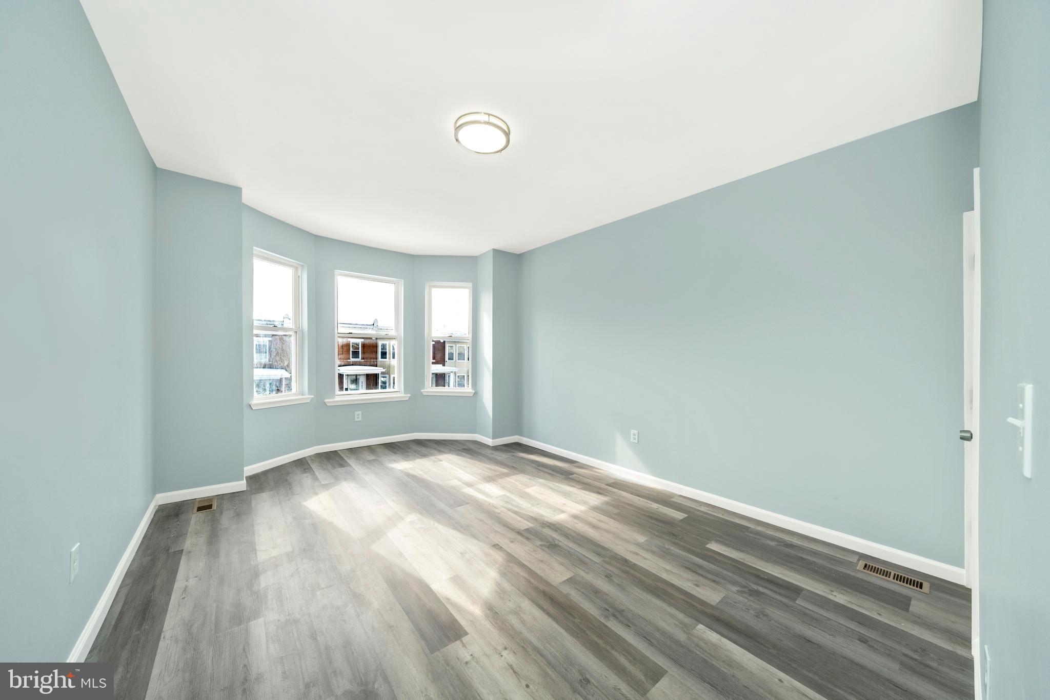2318 West Lanvale Street Baltimore, MD 21216 - Photo 15 of 37 a view of empty room with wooden floor and fan