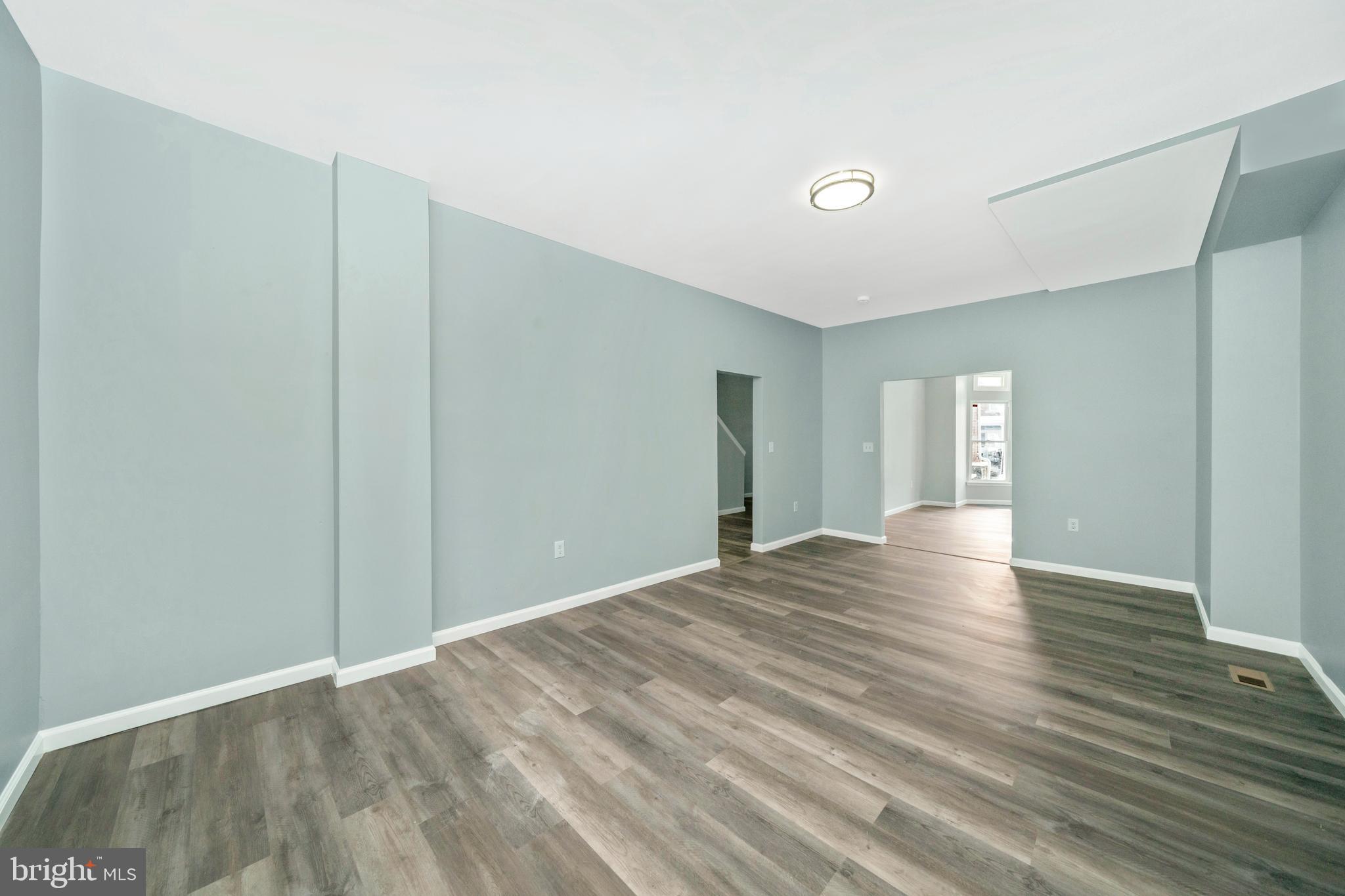 2318 West Lanvale Street Baltimore, MD 21216 - Photo 8 of 37 a view of an empty room with wooden floor and closet