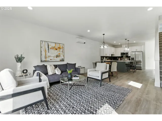 a living room with furniture and kitchen view