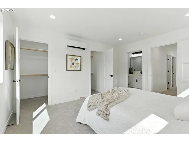 a bedroom with a bed and a painting on the wall