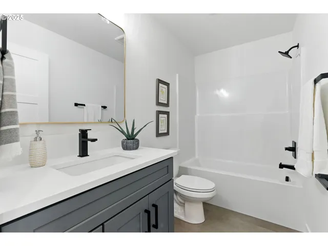 a bathroom with a sink a toilet and a tub