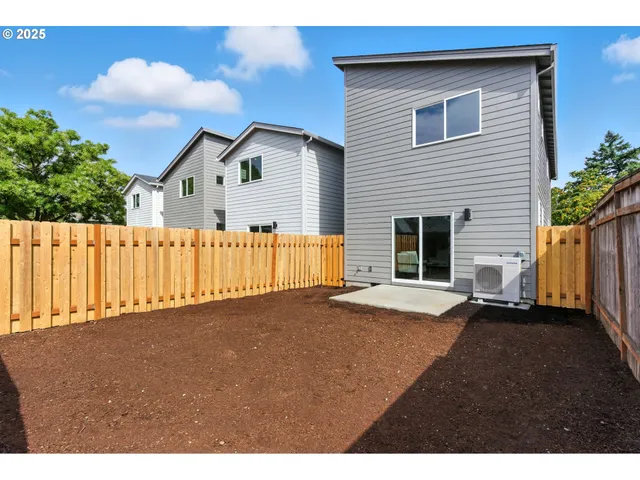 a view of an house with backyard and a garden
