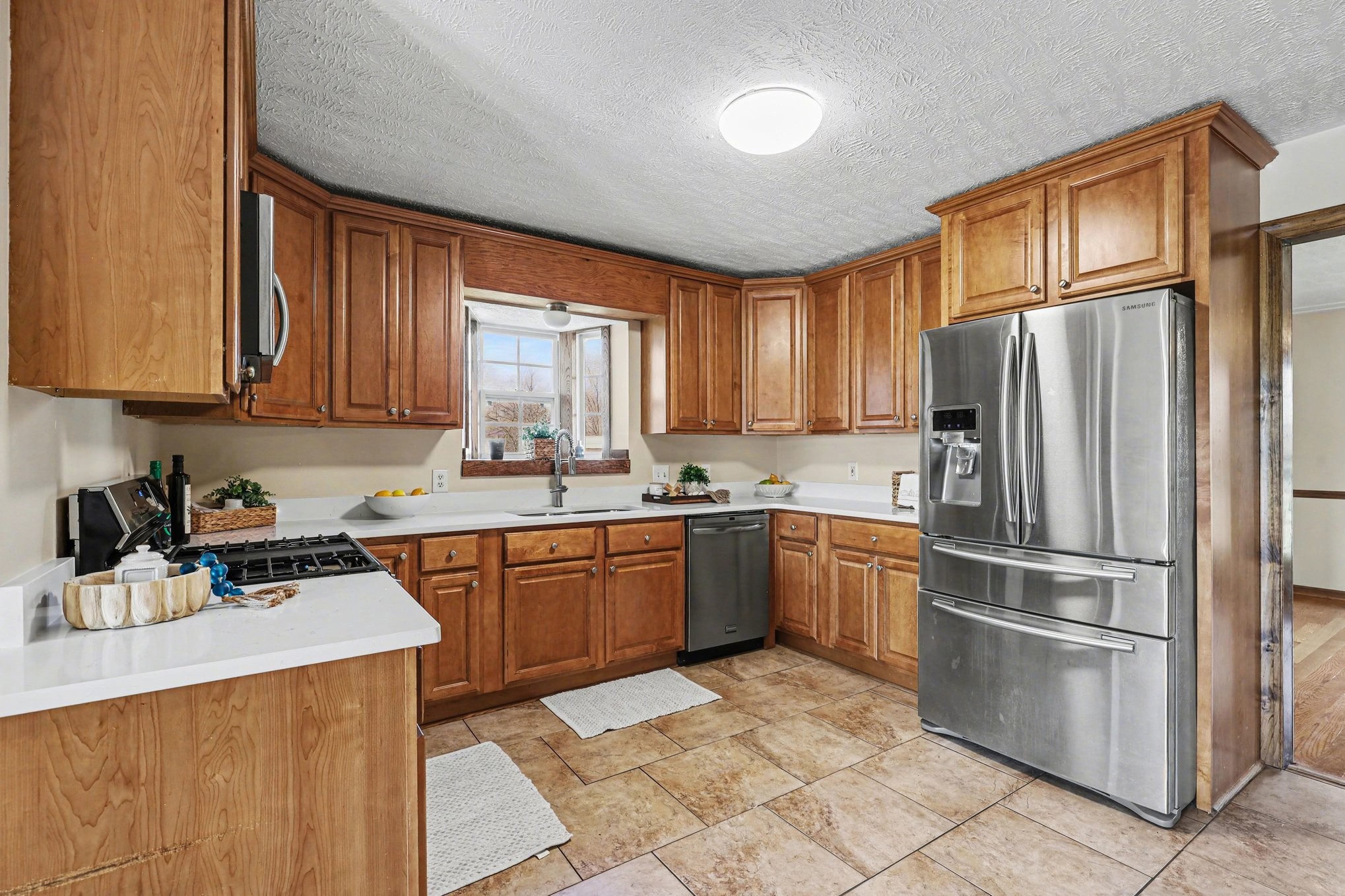 863 Rock Springs Road Castalian Springs, TN 37031 - Photo 12 of 36 a kitchen with stainless steel appliances granite countertop a refrigerator stove top oven and sink