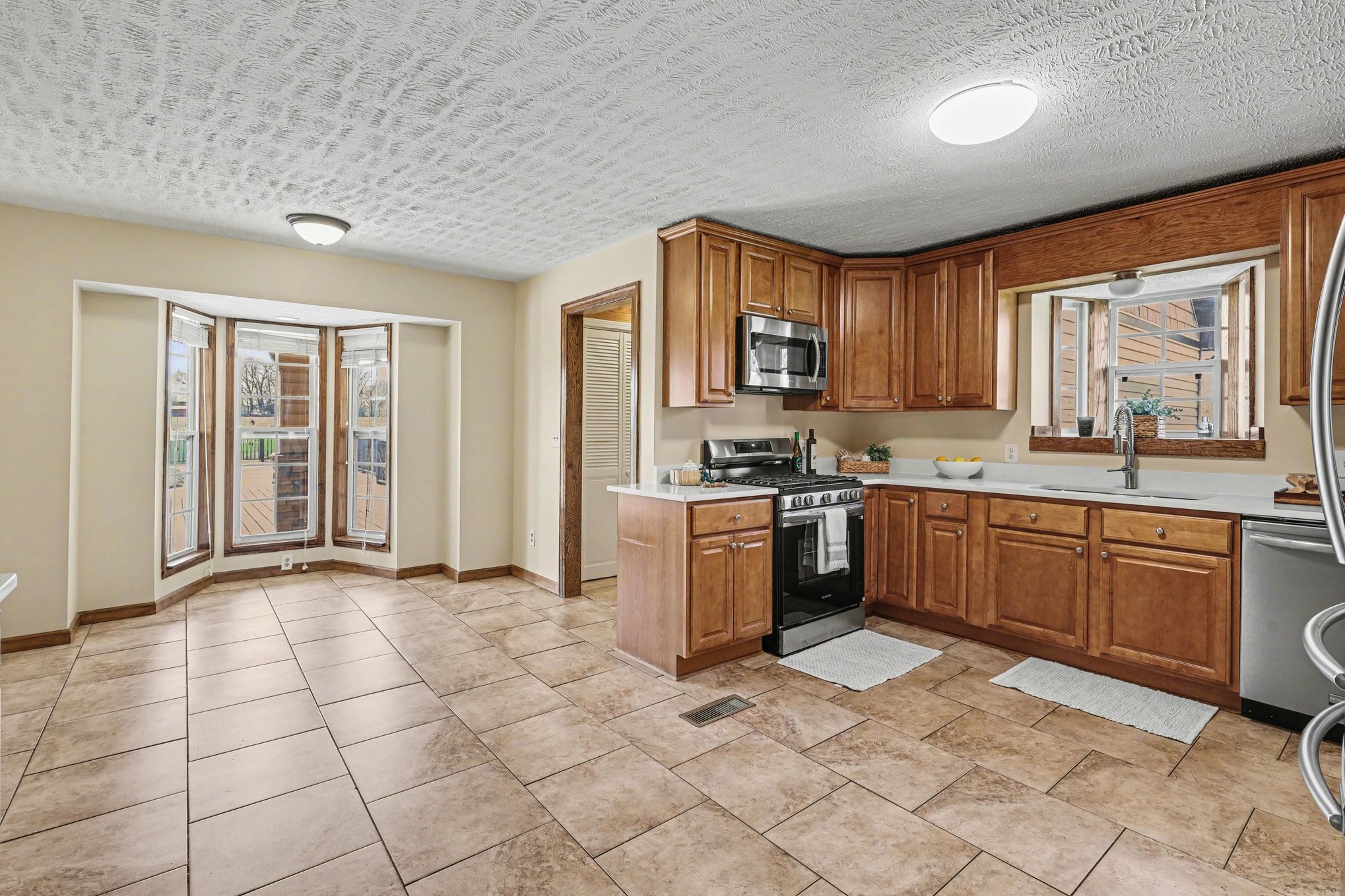 863 Rock Springs Road Castalian Springs, TN 37031 - Photo 13 of 36 a kitchen with stainless steel appliances granite countertop a stove a sink and a refrigerator