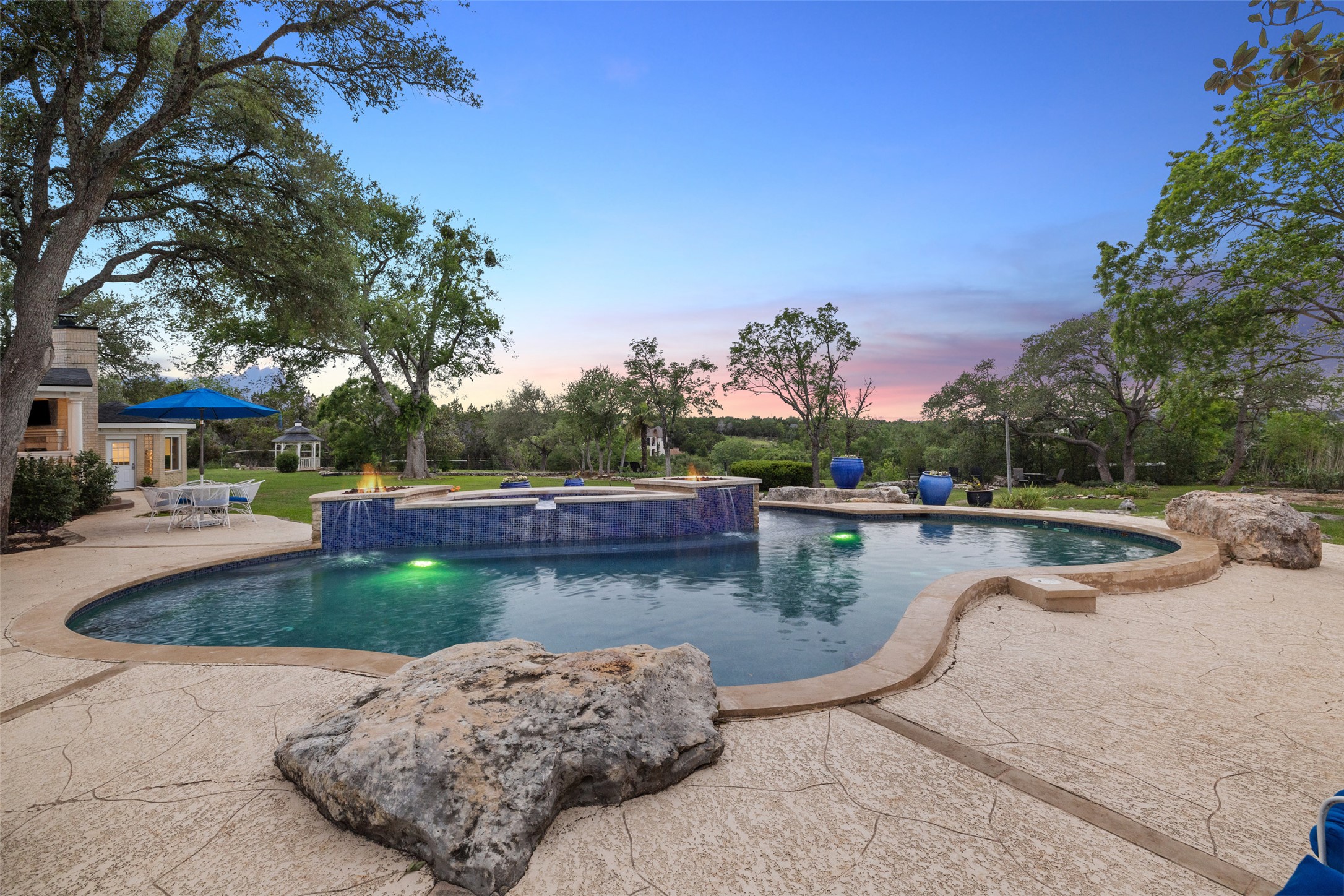 17700 North Rim Drive Leander, TX 78641 - Photo 5 of 38 Pool at dusk featuring a patio and a pool with connected hot tub