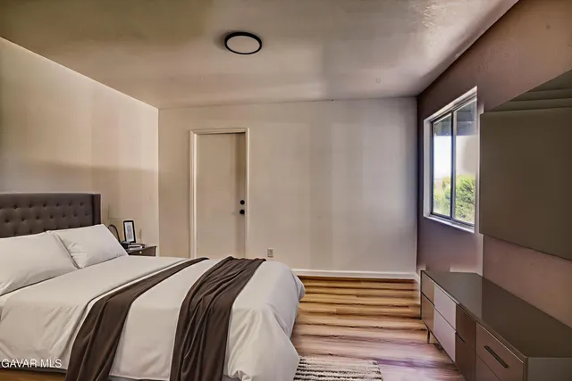 a bedroom with a bed and a window