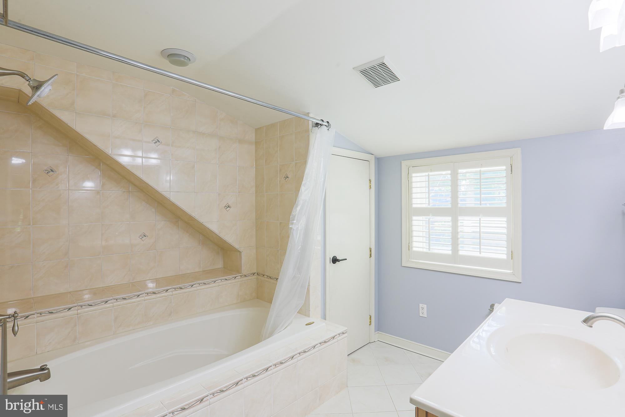 2509 Pinebrush Road Baltimore, MD 21209 - Photo 13 of 20 a bathroom with a bathtub and shower