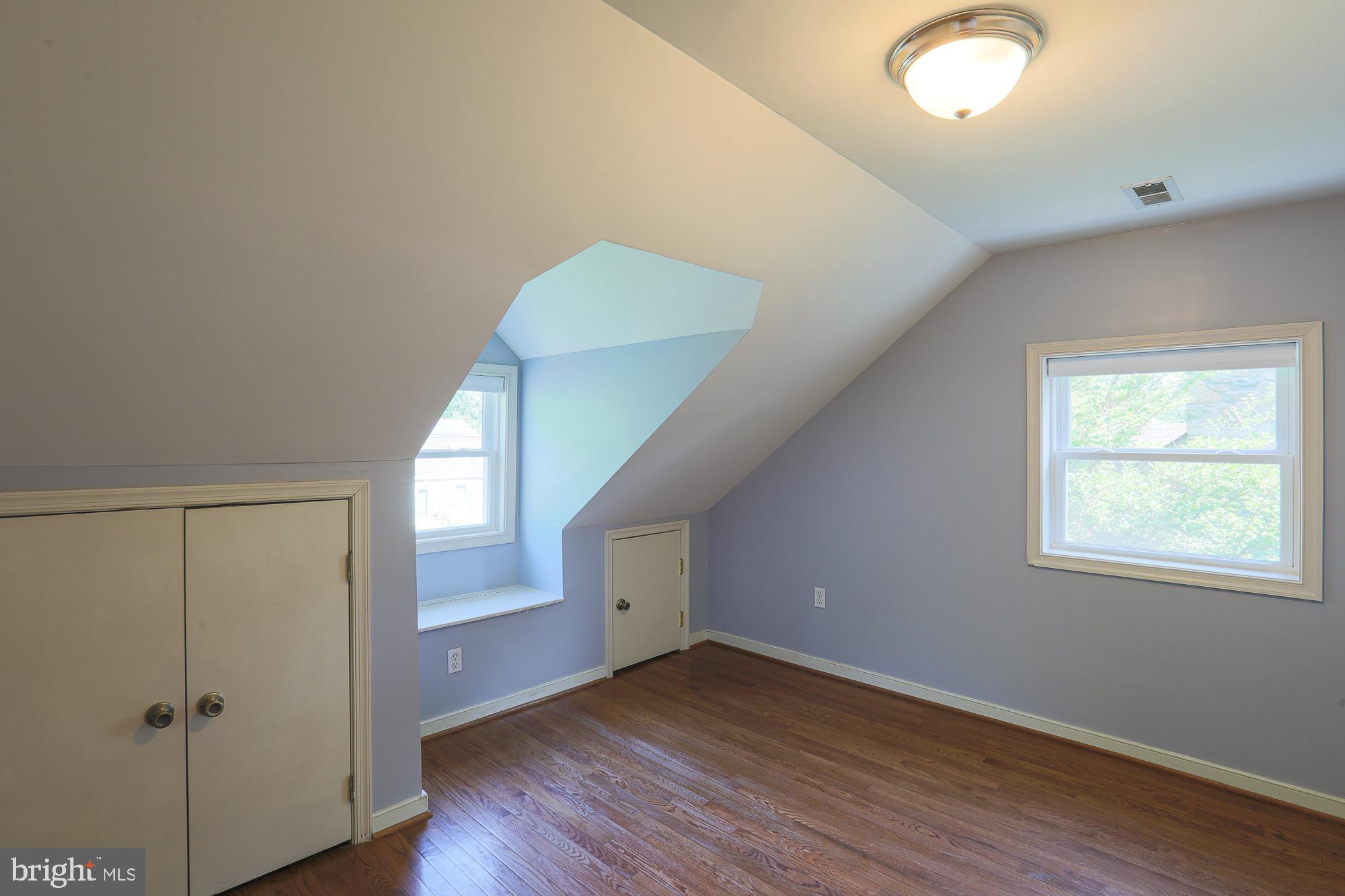 2509 Pinebrush Road Baltimore, MD 21209 - Photo 14 of 20 a view of an empty room with wooden floor and a window