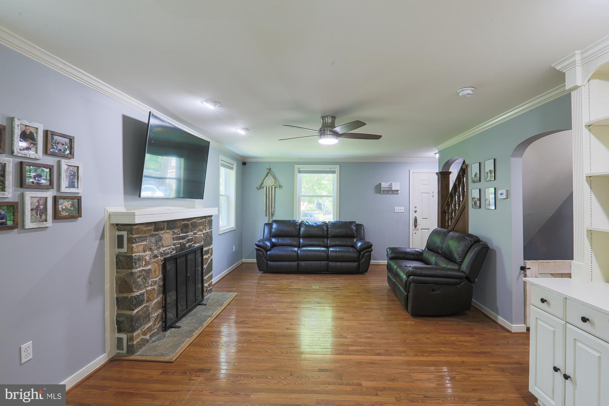 2509 Pinebrush Road Baltimore, MD 21209 - Photo 3 of 20 a living room with furniture flat screen tv and a fireplace