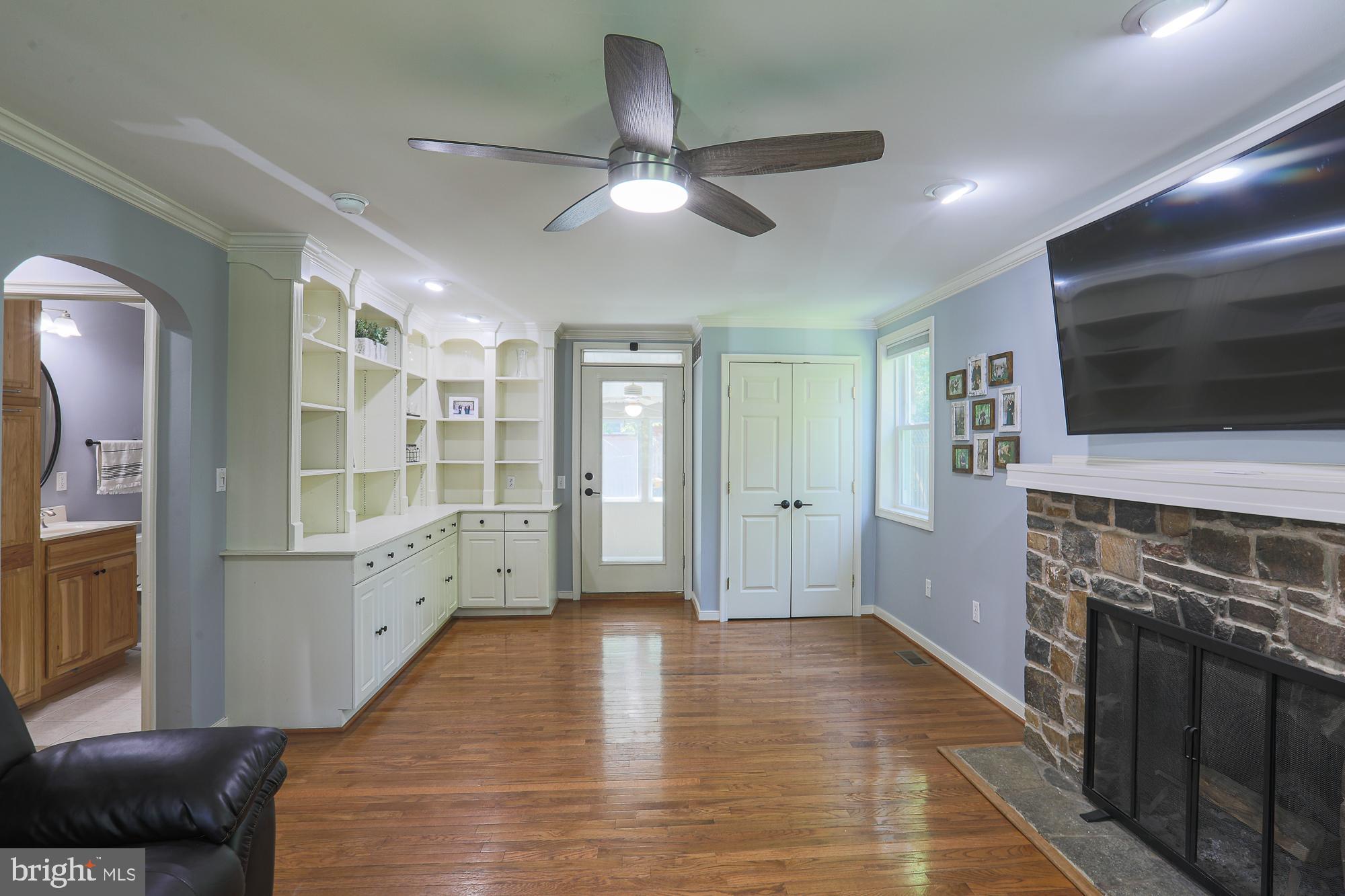2509 Pinebrush Road Baltimore, MD 21209 - Photo 4 of 20 a view of a livingroom with wooden floor and a kitchen