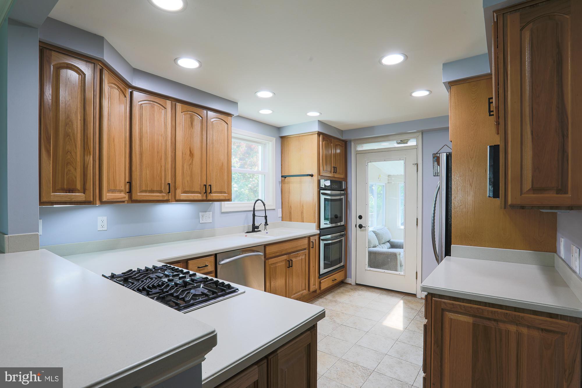 2509 Pinebrush Road Baltimore, MD 21209 - Photo 6 of 20 a kitchen that has a sink stainless steel appliances a counter space and cabinets