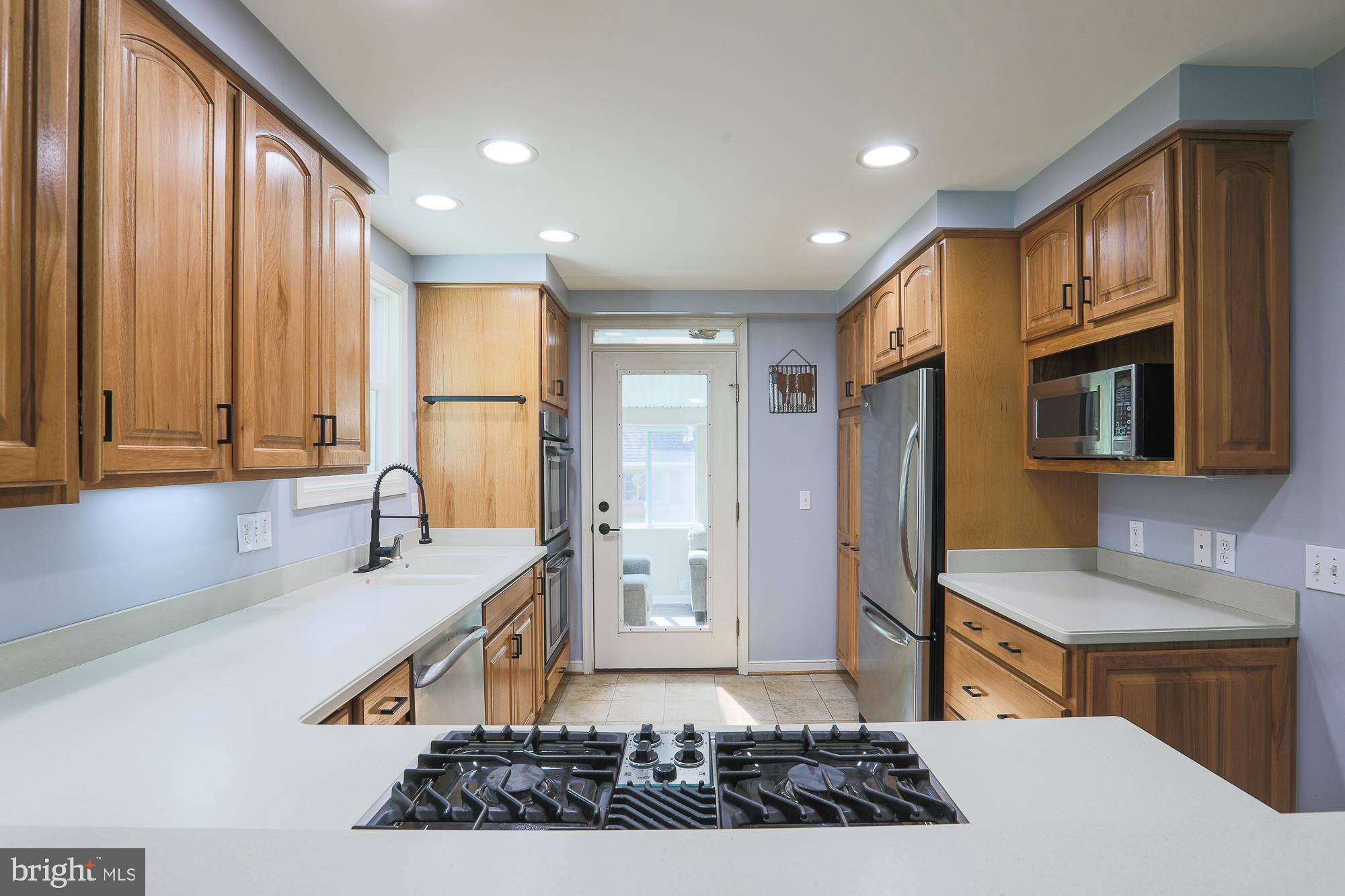 2509 Pinebrush Road Baltimore, MD 21209 - Photo 7 of 20 a kitchen with stainless steel appliances granite countertop a sink stove and cabinets