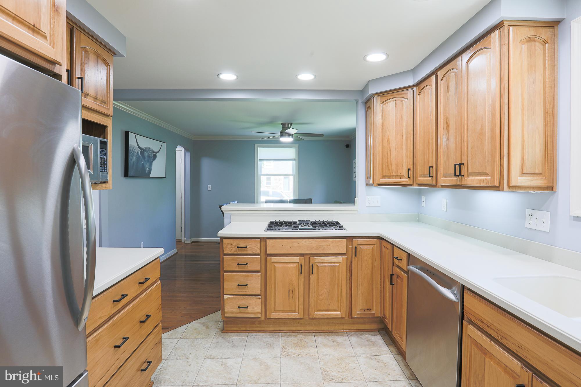 2509 Pinebrush Road Baltimore, MD 21209 - Photo 8 of 20 a kitchen that has a sink cabinets appliances and a window