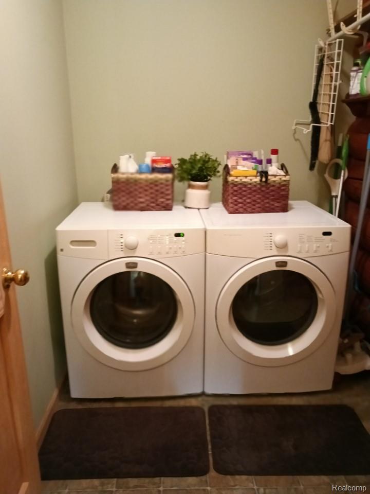 10374 Wilson Road Otisville, MI 48463 - Photo 64 of 99 Laundry area featuring washer and clothes dryer and tile patterned flooring