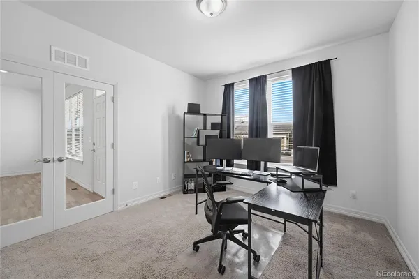 a bedroom with a bed and a ceiling fan