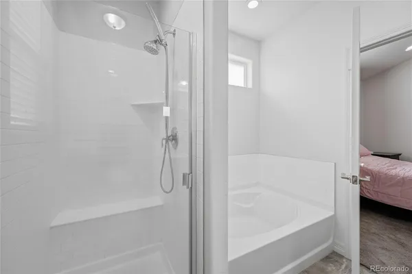 a bathroom with a double vanity sink and shower