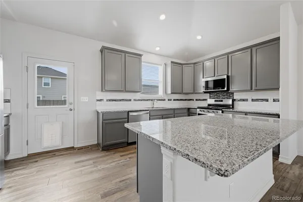 a kitchen with a refrigerator and a sink
