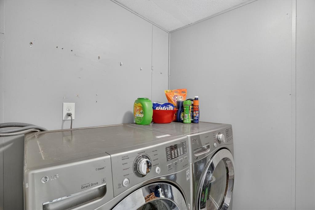 6602 Ashley Court Granbury, TX 76049 - Photo 19 of 35 Laundry area with durable panel walls and a convenient electrical outlet