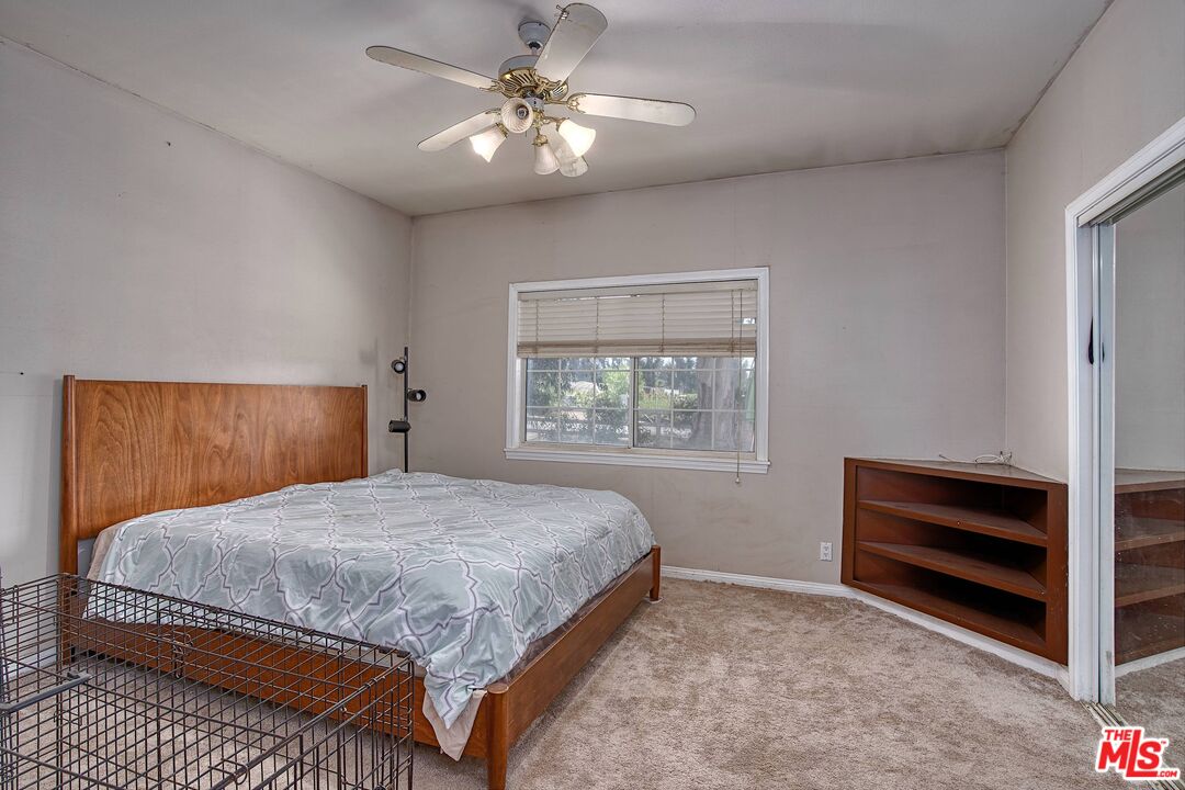5565 Balcom Canyon Road Somis, CA 93066 - Photo 19 of 72 a bedroom with a bed chandelier and a window