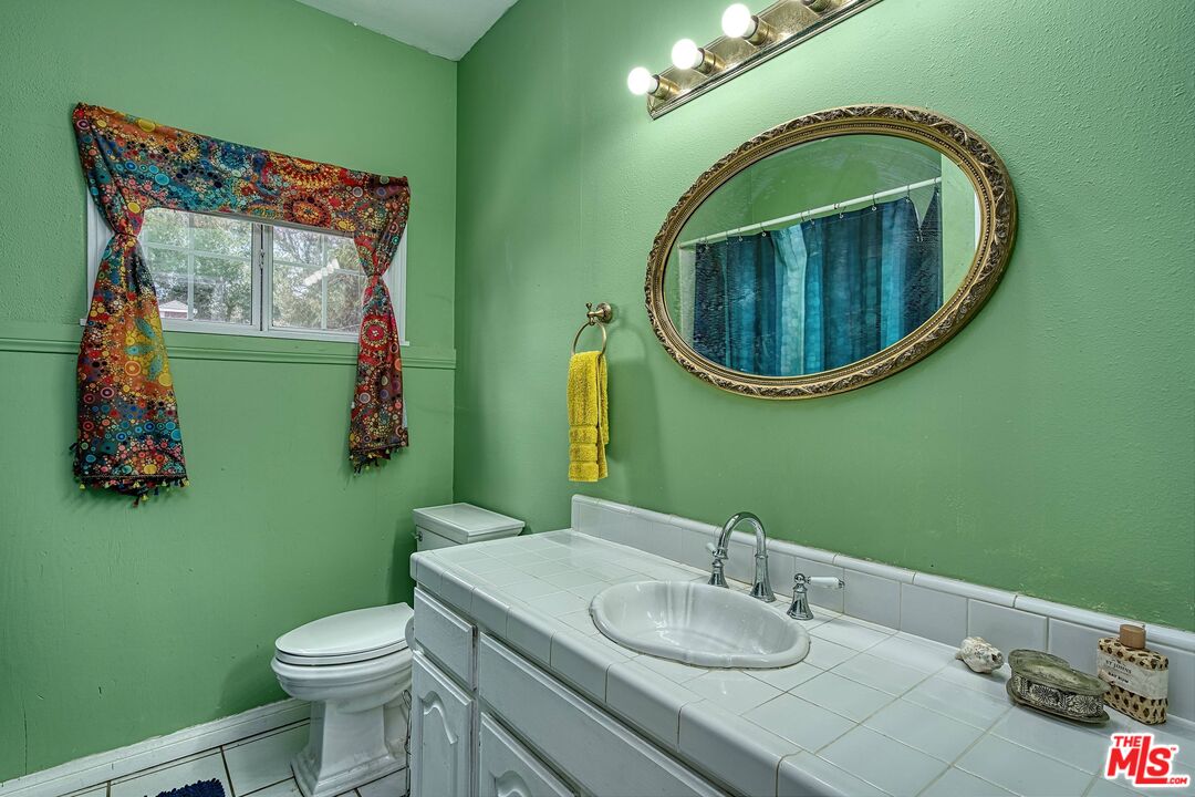 5565 Balcom Canyon Road Somis, CA 93066 - Photo 21 of 72 a bathroom with a toilet sink and mirror