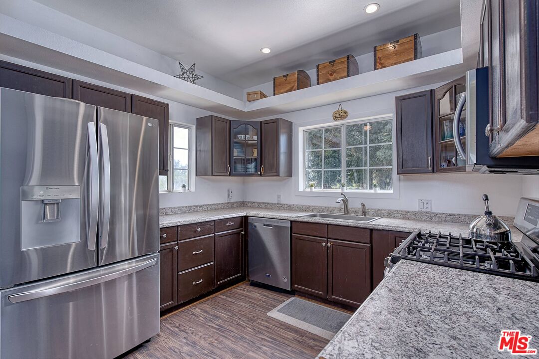 5565 Balcom Canyon Road Somis, CA 93066 - Photo 29 of 72 a kitchen with stainless steel appliances granite countertop a sink stove and refrigerator