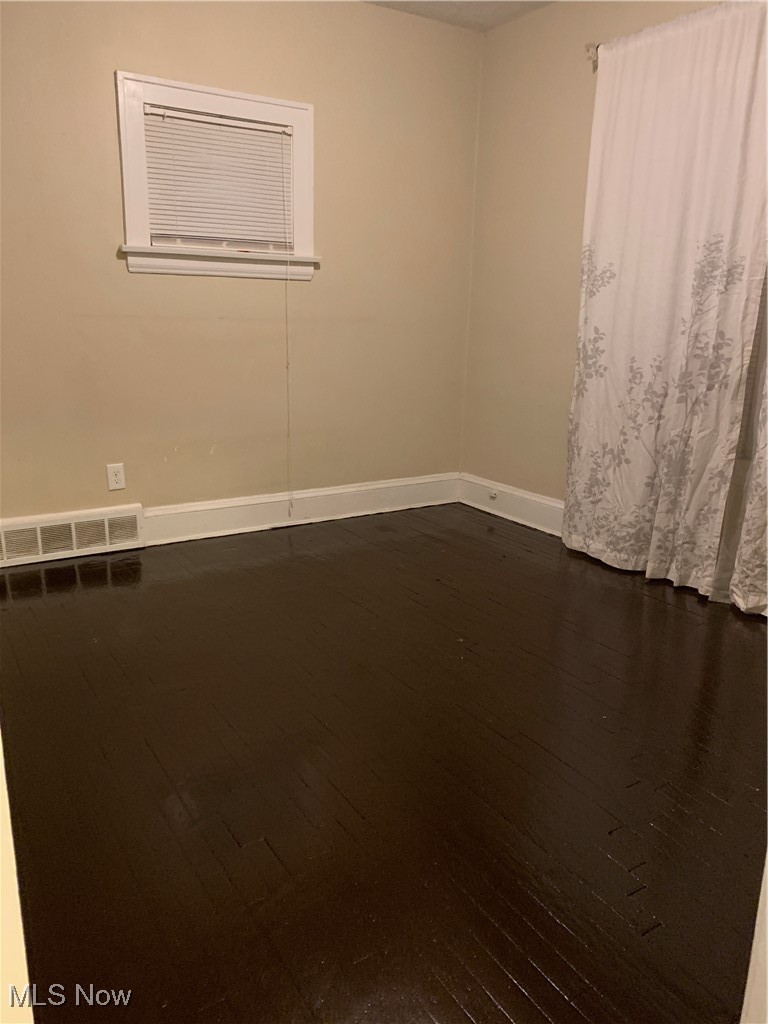 13000 Rockside Road Cleveland, OH 44125 - Photo 16 of 41 Spare room featuring dark hardwood / wood-style flooring