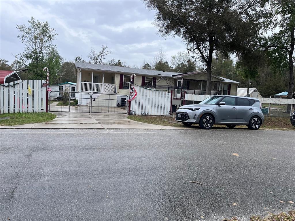 203 Vancouver Circle Interlachen, FL 32148 - Photo 1 of 25 a front view of a house with cars parked on road