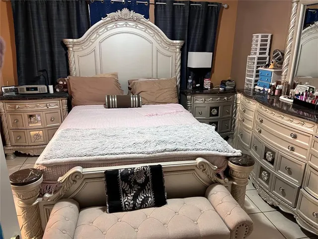 a bedroom with a bed and a dresser