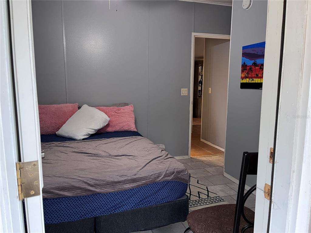 203 Vancouver Circle Interlachen, FL 32148 - Photo 15 of 25 a bedroom with a bed and painting on the wall