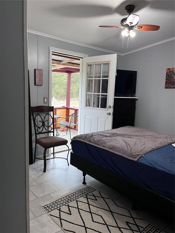 203 Vancouver Circle Interlachen, FL 32148 - Photo 16 of 25 a bedroom with a bed and a lamp on table