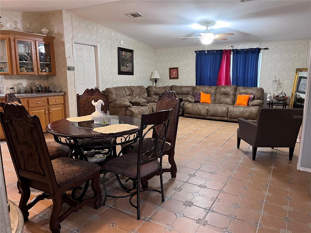203 Vancouver Circle Interlachen, FL 32148 - Photo 21 of 25 a living room with furniture a dining table and kitchen view