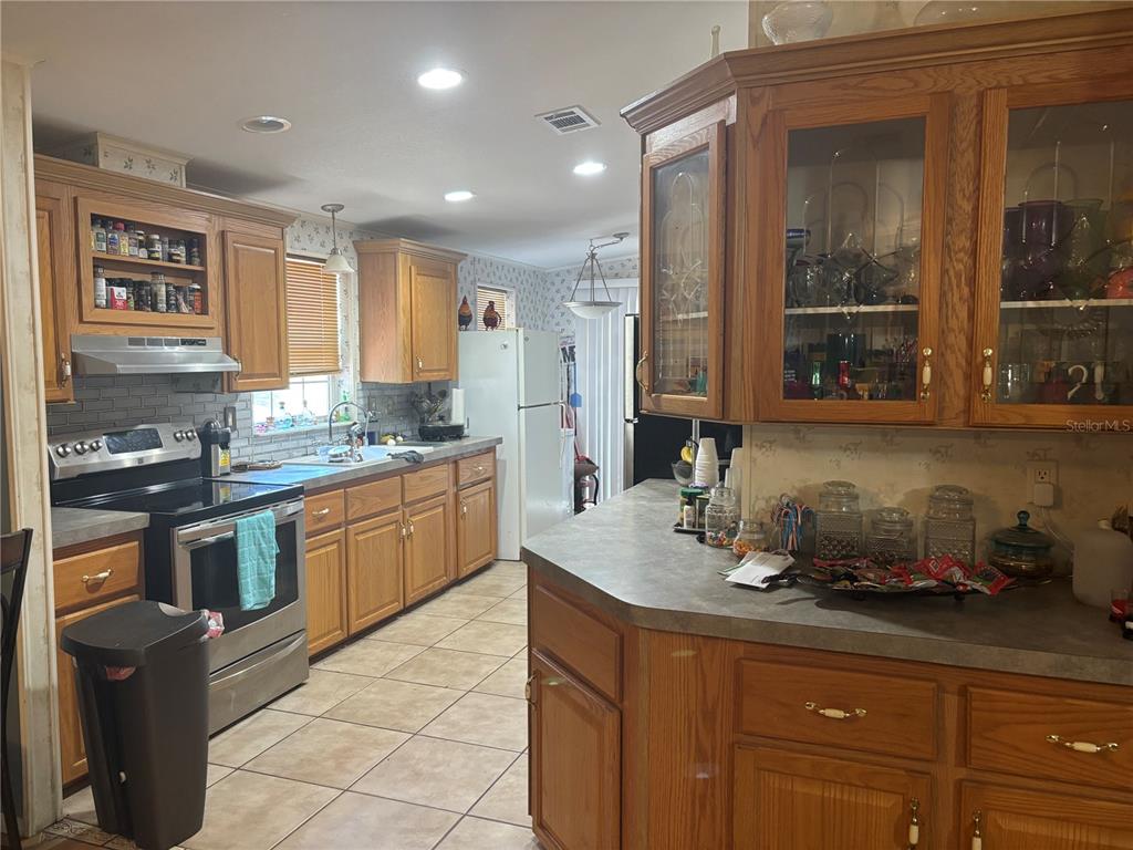 203 Vancouver Circle Interlachen, FL 32148 - Photo 25 of 25 a kitchen with stainless steel appliances granite countertop a sink stove and cabinets