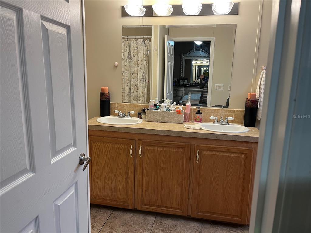 203 Vancouver Circle Interlachen, FL 32148 - Photo 10 of 25 a bathroom with a sink and a mirror