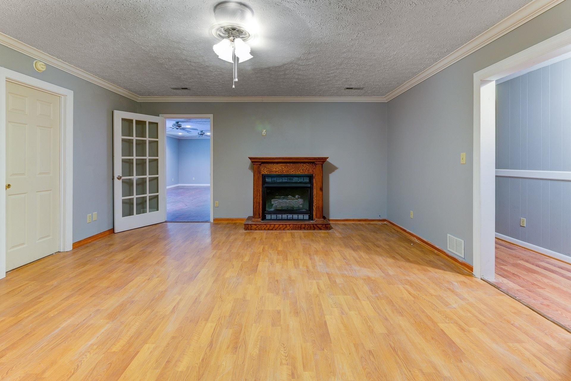 5028 Henry Road Henry, VA 24102 - Photo 13 of 44 a view of empty room with wooden floor and fireplace