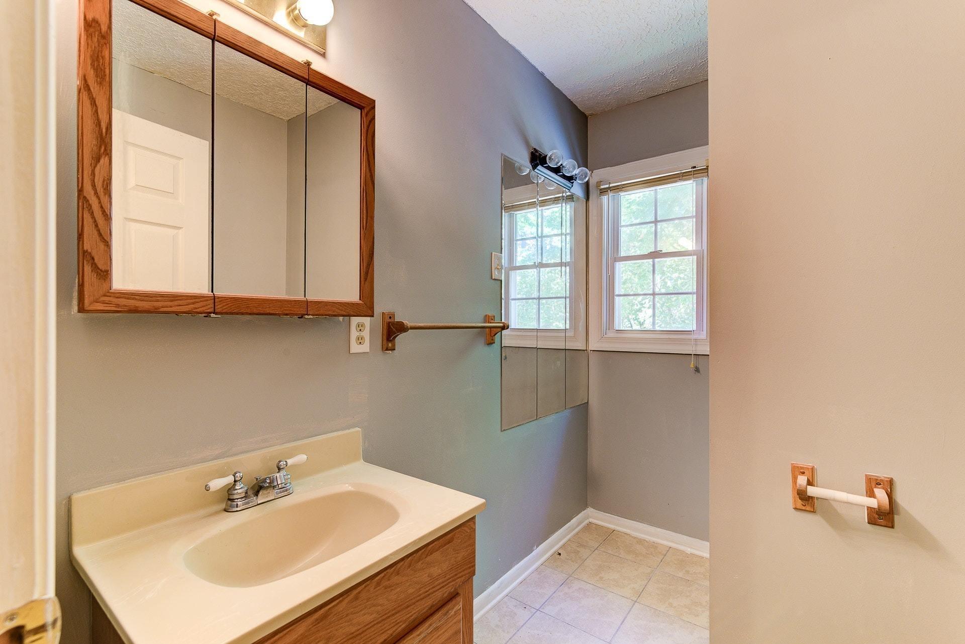 5028 Henry Road Henry, VA 24102 - Photo 14 of 44 a bathroom with a sink and a mirror