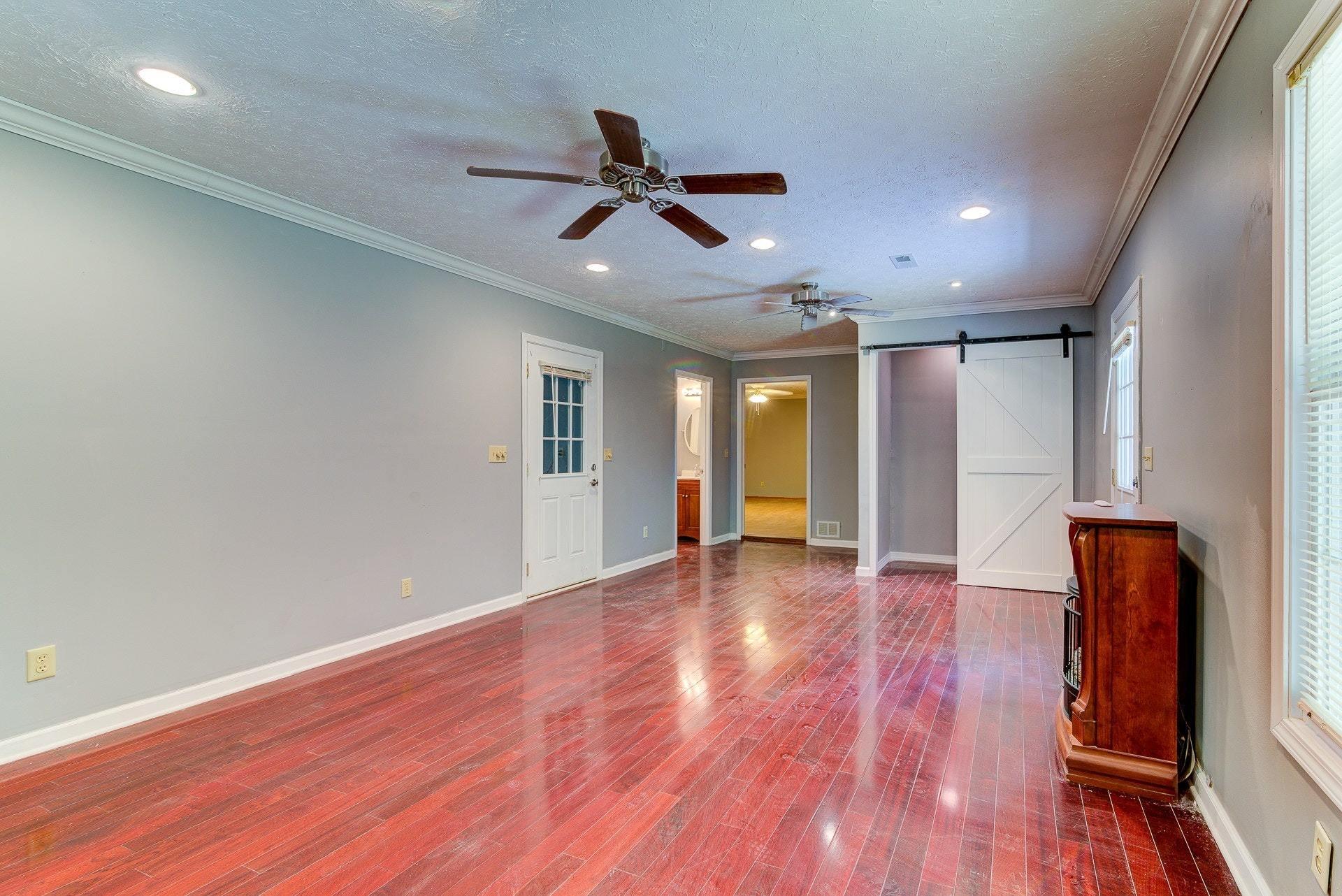 5028 Henry Road Henry, VA 24102 - Photo 17 of 44 a view of empty room with wooden floor and fan