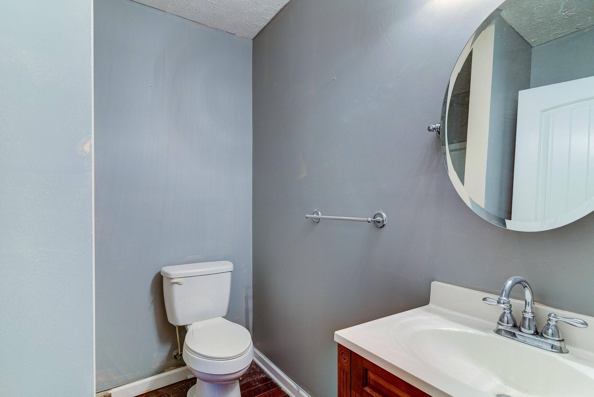 5028 Henry Road Henry, VA 24102 - Photo 18 of 44 a bathroom with a toilet sink and mirror