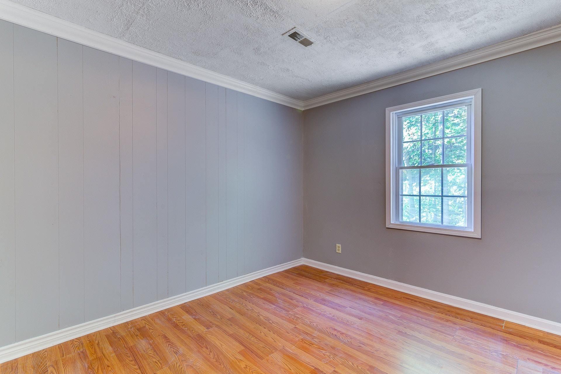 5028 Henry Road Henry, VA 24102 - Photo 24 of 44 a view of an empty room with wooden floor and a window