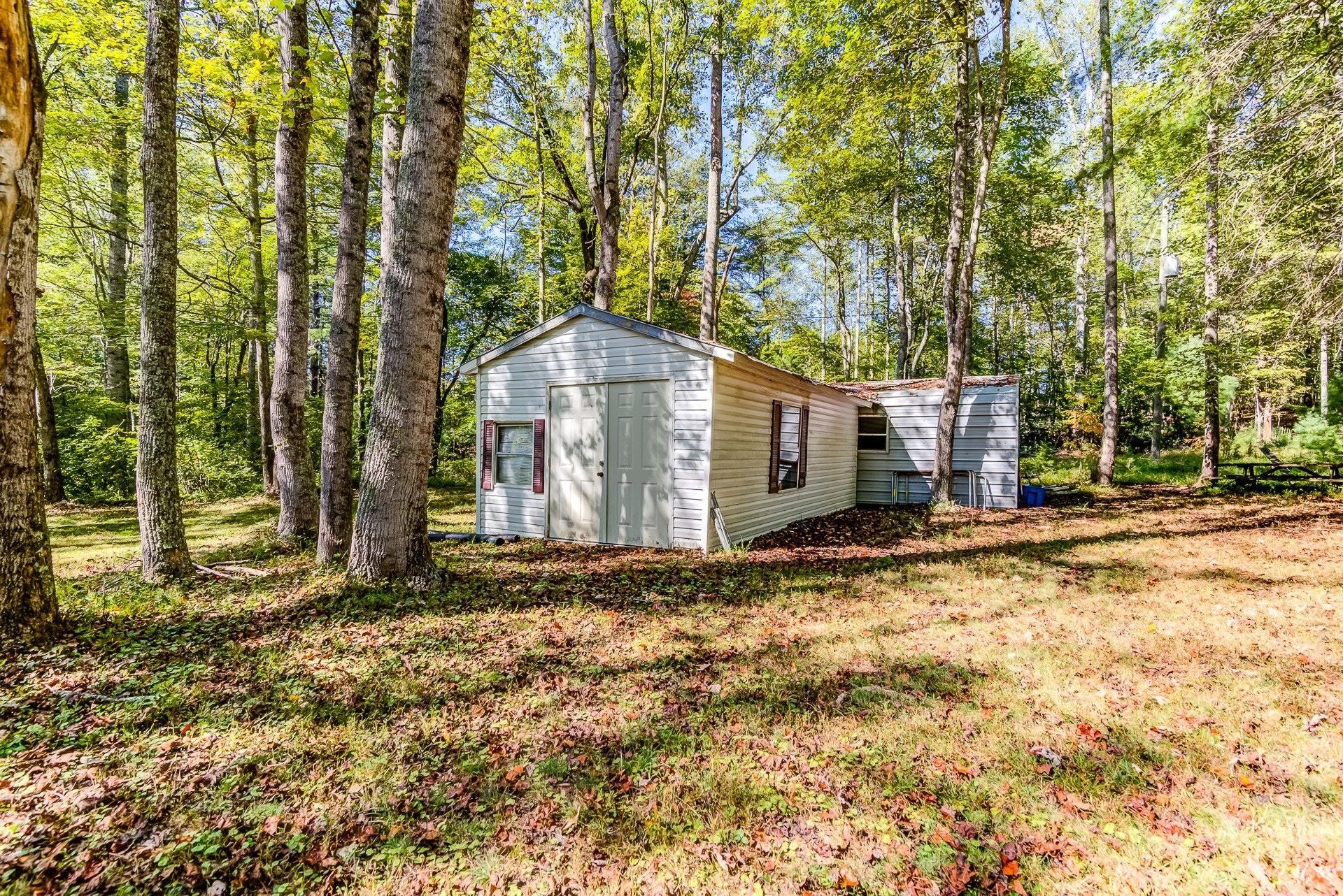 5028 Henry Road Henry, VA 24102 - Photo 39 of 44 a wooden house with trees in front of it
