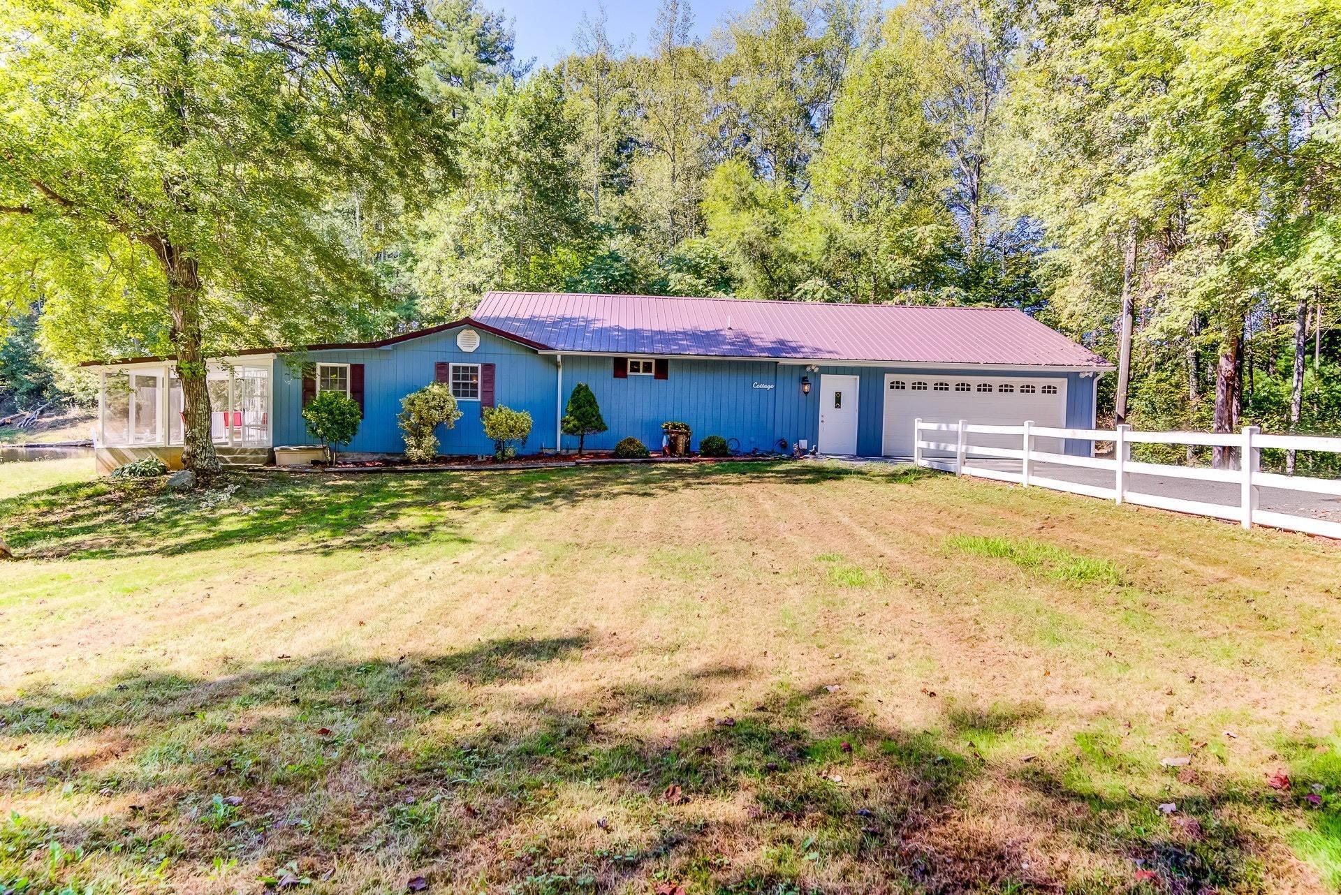 5028 Henry Road Henry, VA 24102 - Photo 5 of 44 a house that has a tree in front of it