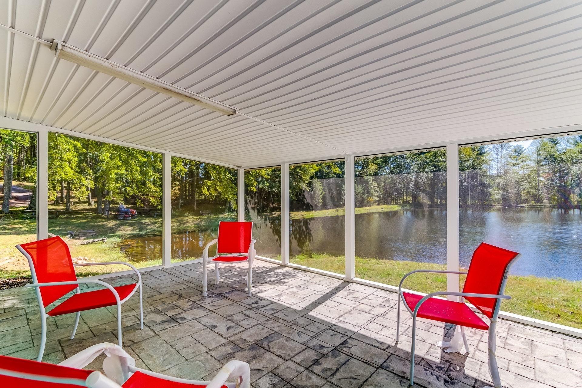 5028 Henry Road Henry, VA 24102 - Photo 9 of 44 a view of a patio with a dining table and chairs with wooden floor and fence
