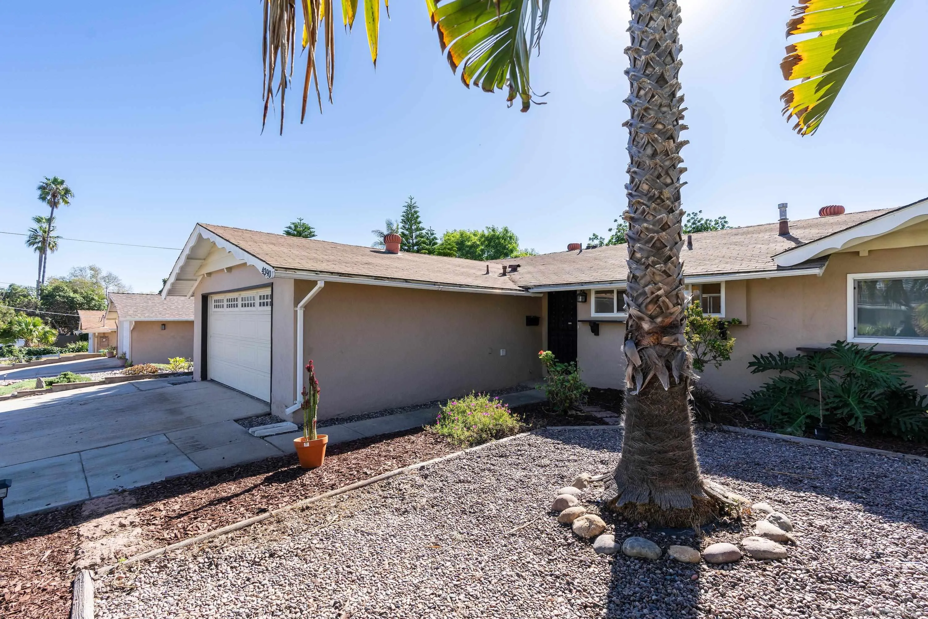 4390 Rolfe Road San Diego, CA 92117 - Photo 1 of 28 a front view of a house with garden