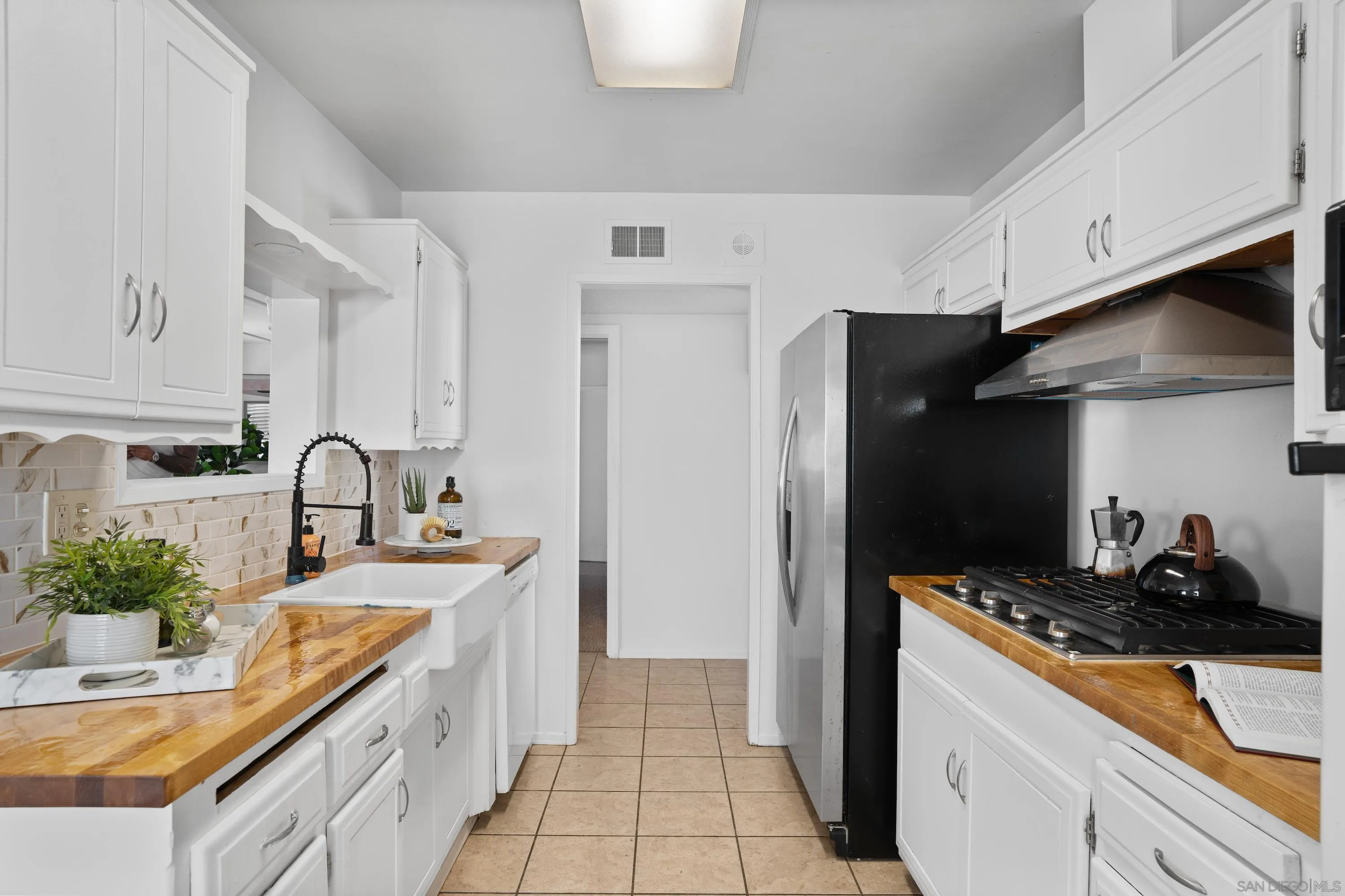 4390 Rolfe Road San Diego, CA 92117 - Photo 12 of 28 a kitchen with stainless steel appliances granite countertop a sink stove and refrigerator