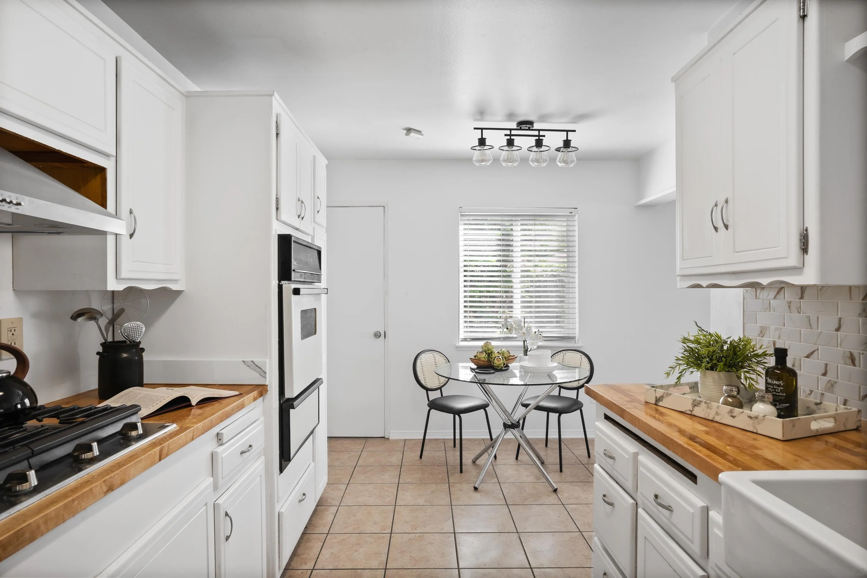 4390 Rolfe Road San Diego, CA 92117 - Photo 13 of 28 a kitchen that has a table and chairs in it