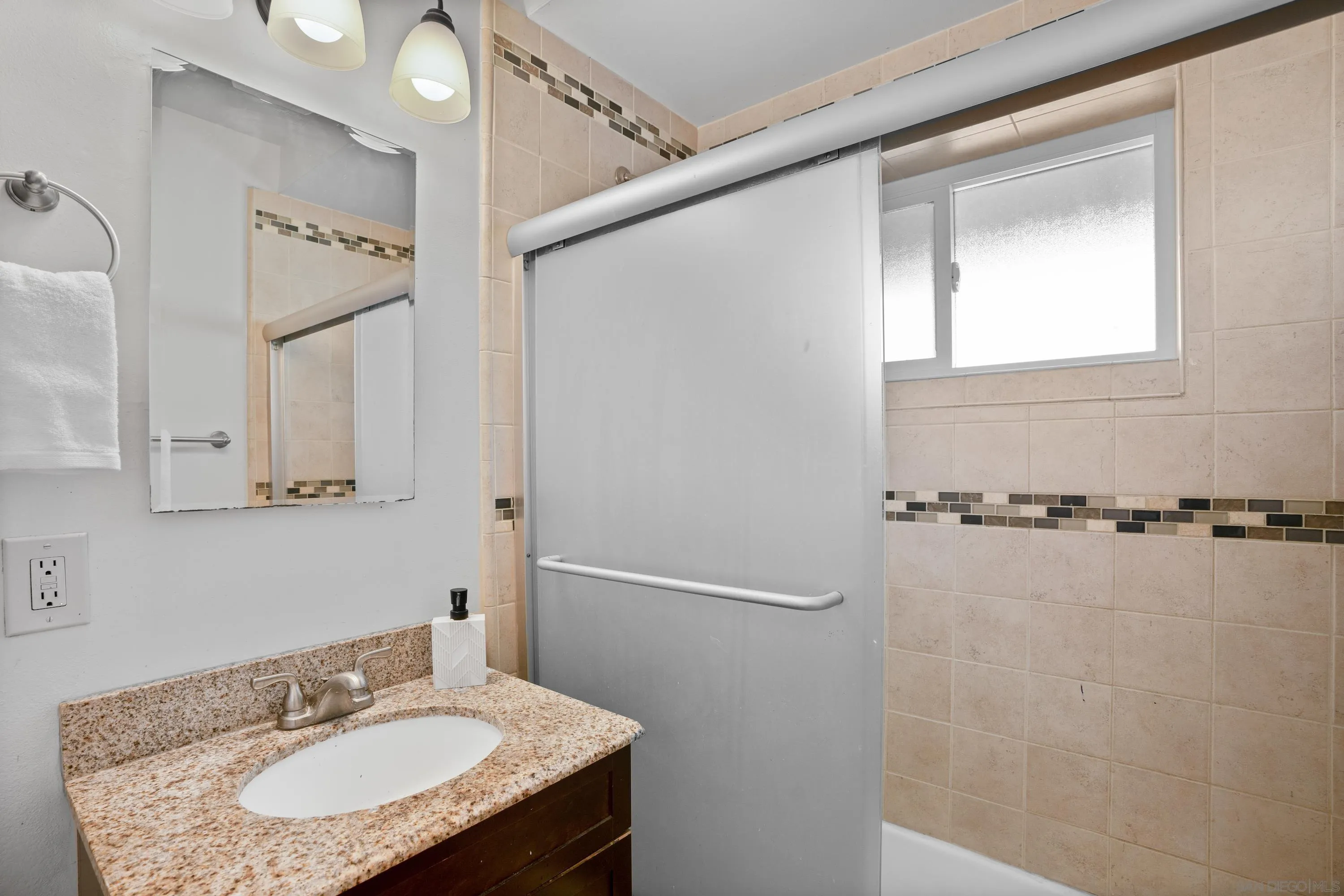 4390 Rolfe Road San Diego, CA 92117 - Photo 17 of 28 a bathroom with a sink and a mirror