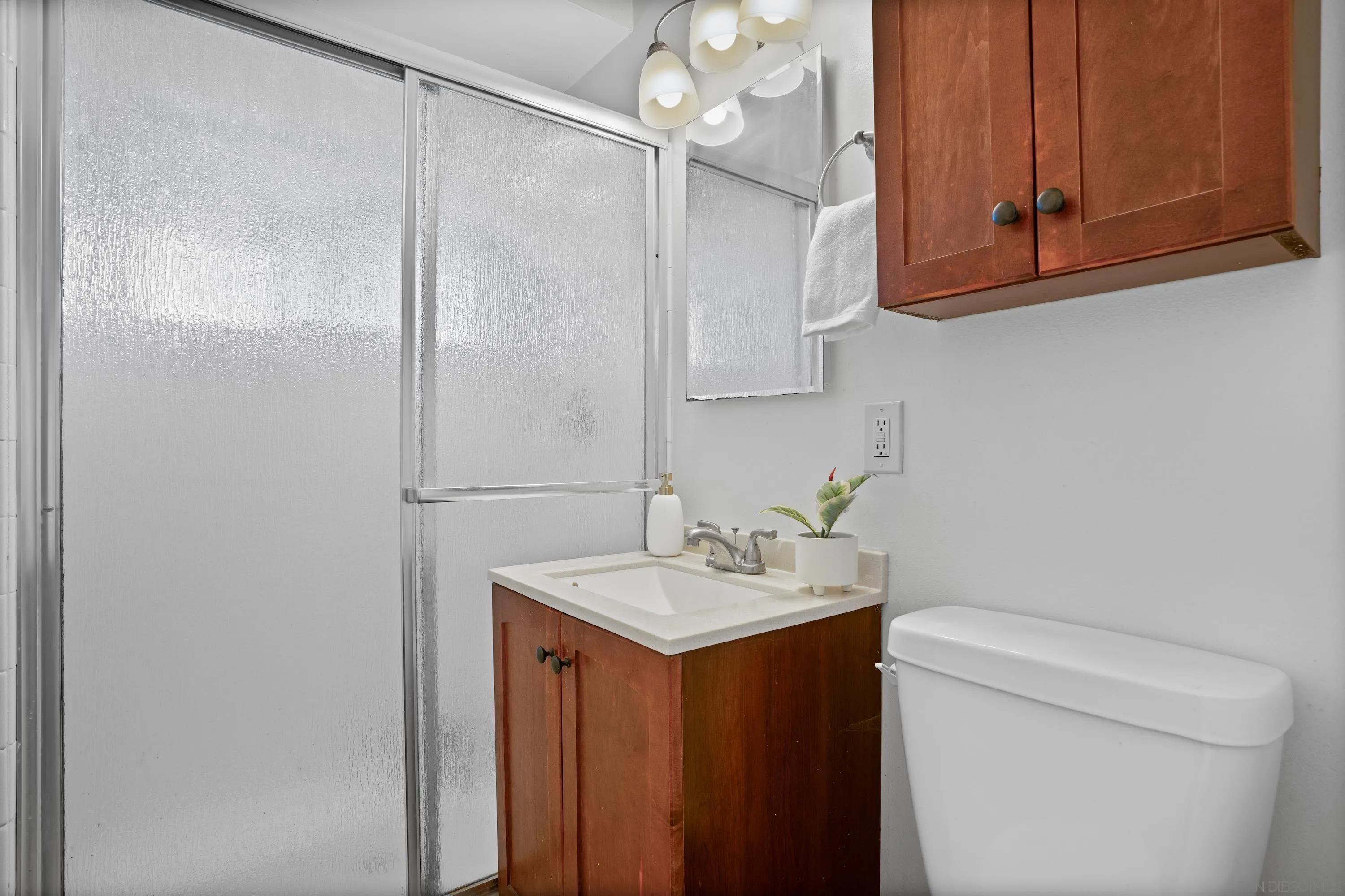 4390 Rolfe Road San Diego, CA 92117 - Photo 18 of 28 a bathroom with a sink a toilet and vanity