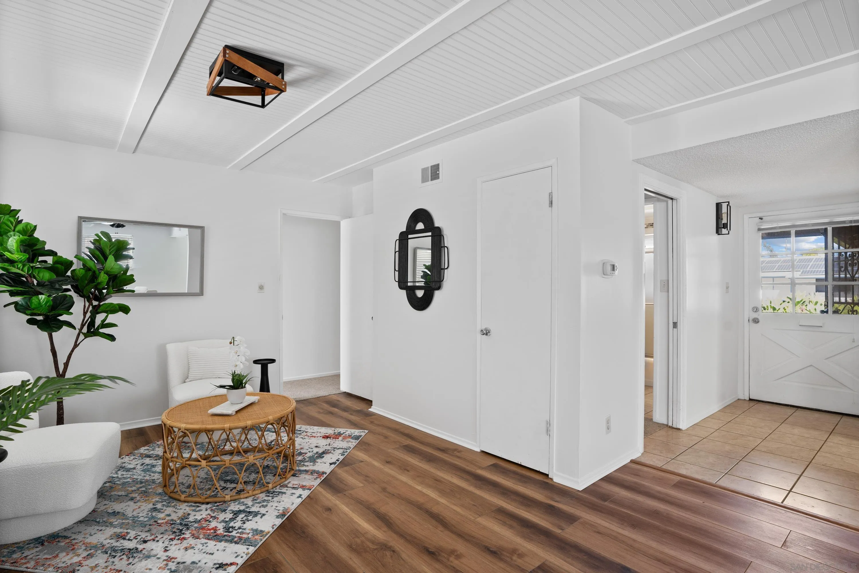 4390 Rolfe Road San Diego, CA 92117 - Photo 9 of 28 a bedroom with a bed and a potted plant