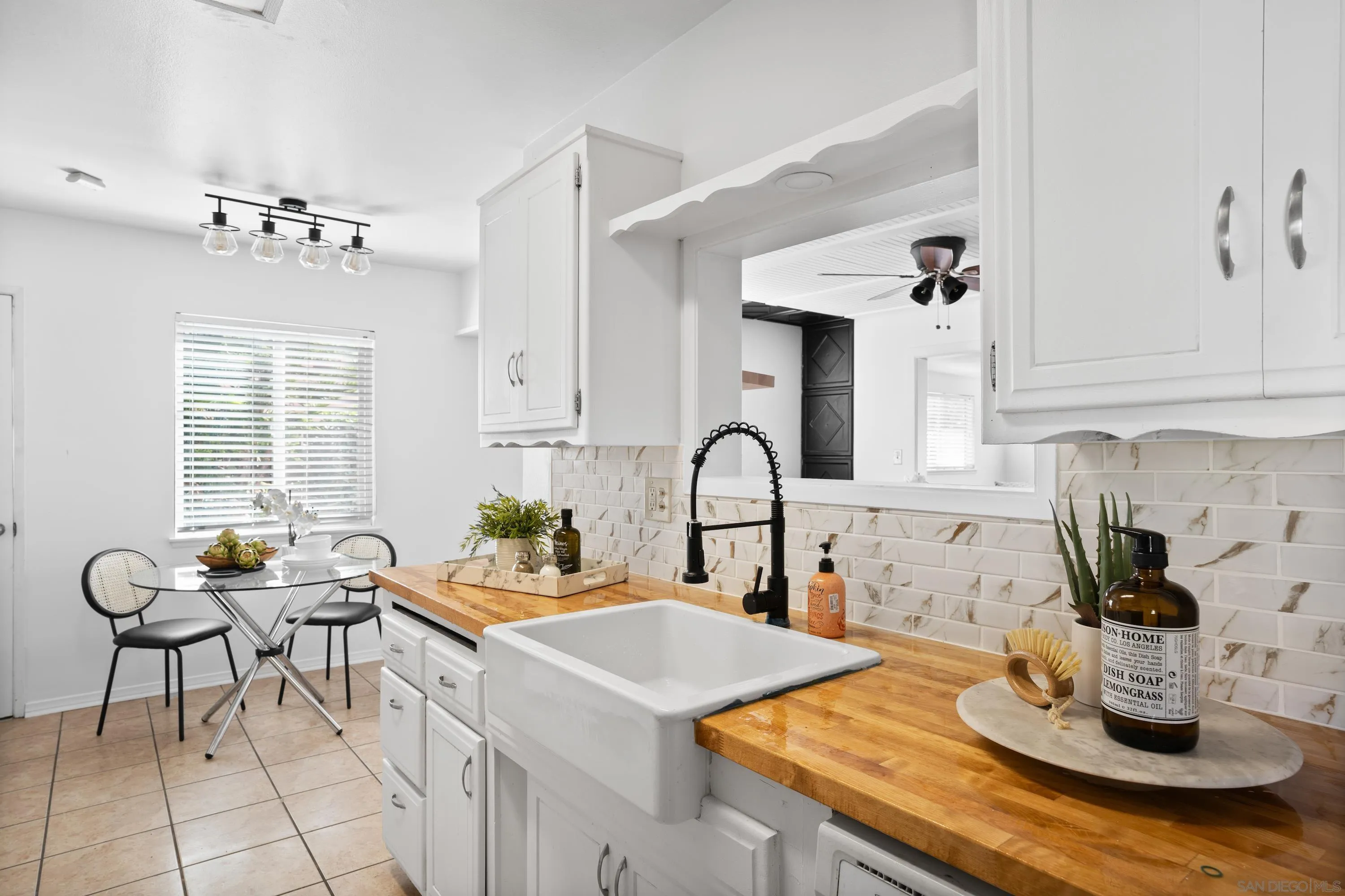 4390 Rolfe Road San Diego, CA 92117 - Photo 10 of 28 a kitchen with a sink cabinets and dining table