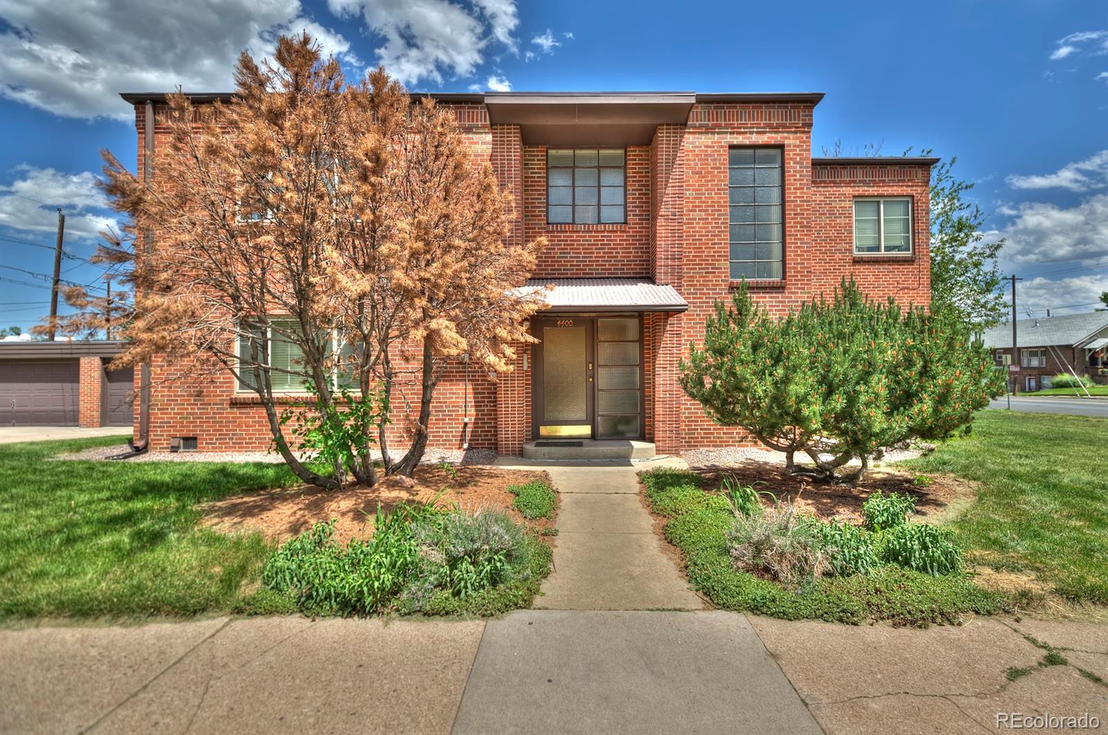 4400 Grove Street, Unit 4 Denver, CO 80211 - Photo 1 of 1 front view of a house with a yard